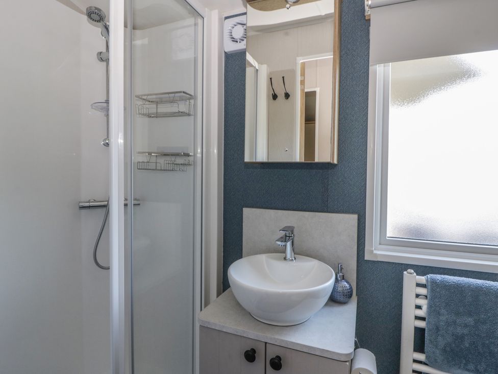 A bathroom with a shower and sink at Santa Maria in Llandysul
