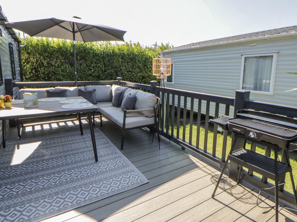 An outdoor patio with a sofa and table at Santa Maria in Llandysul