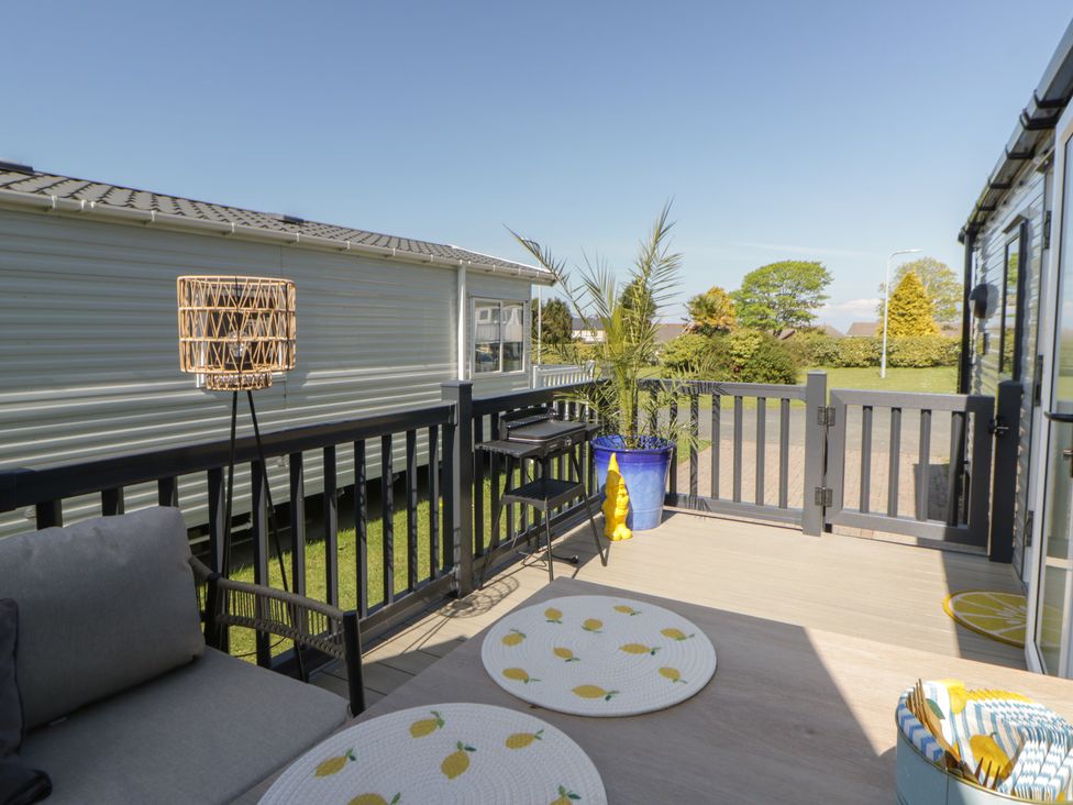 An outdoor patio with furniture and plants at Santa Maria in Llandysul