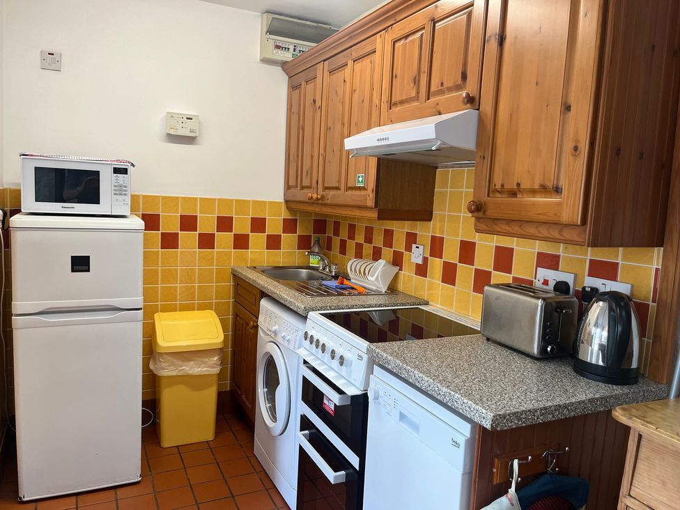 A kitchen with appliances and cabinets at Starling Cottage near Cowbridge