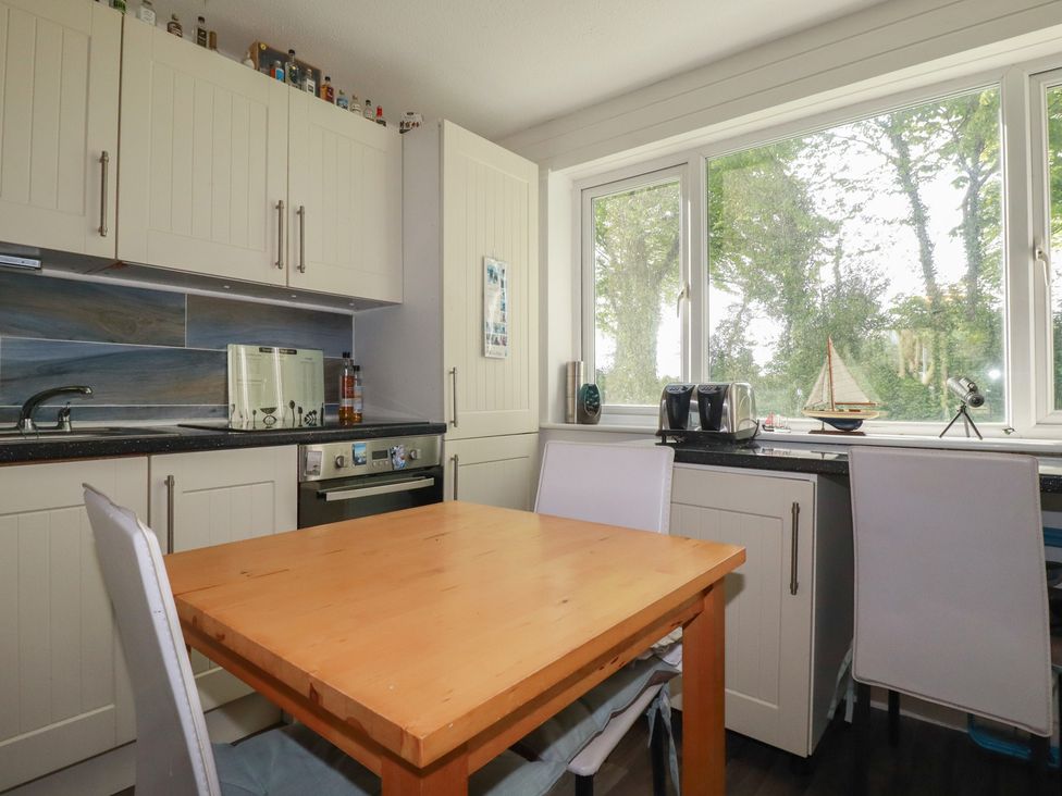 A kitchen with a table and chairs at 140 Atlantic Reach Newquay