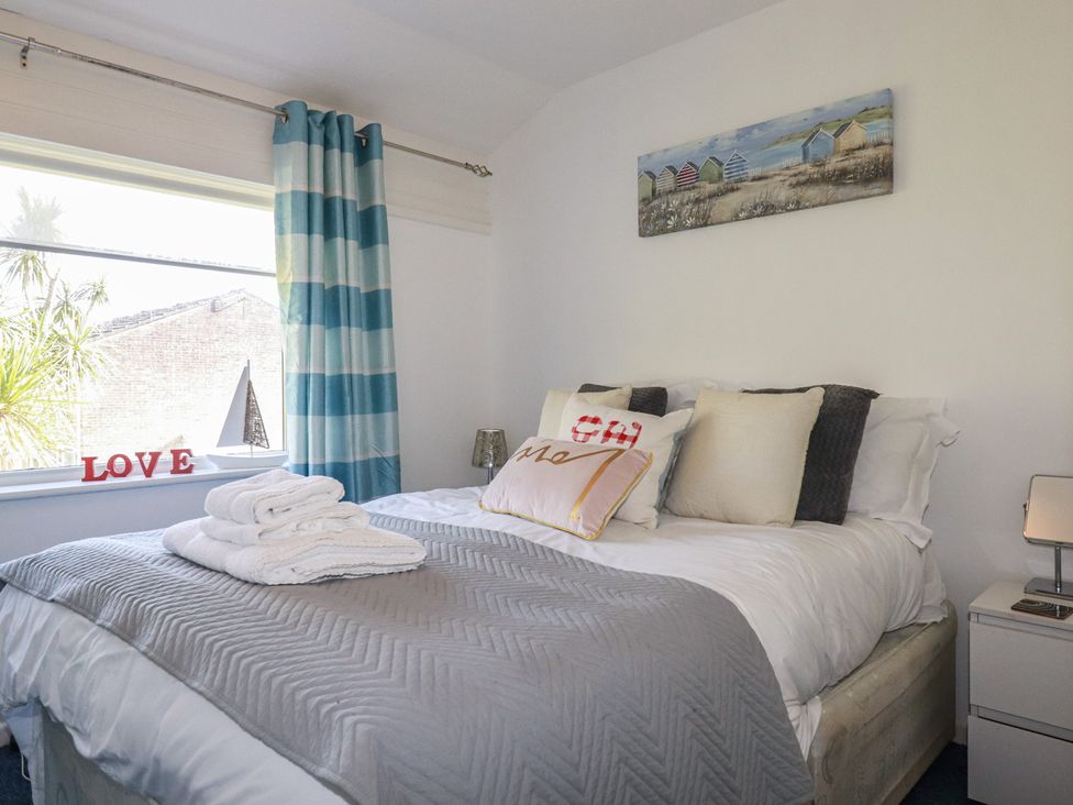 A bedroom with a bed and pillows at 140 Atlantic Reach in Newquay