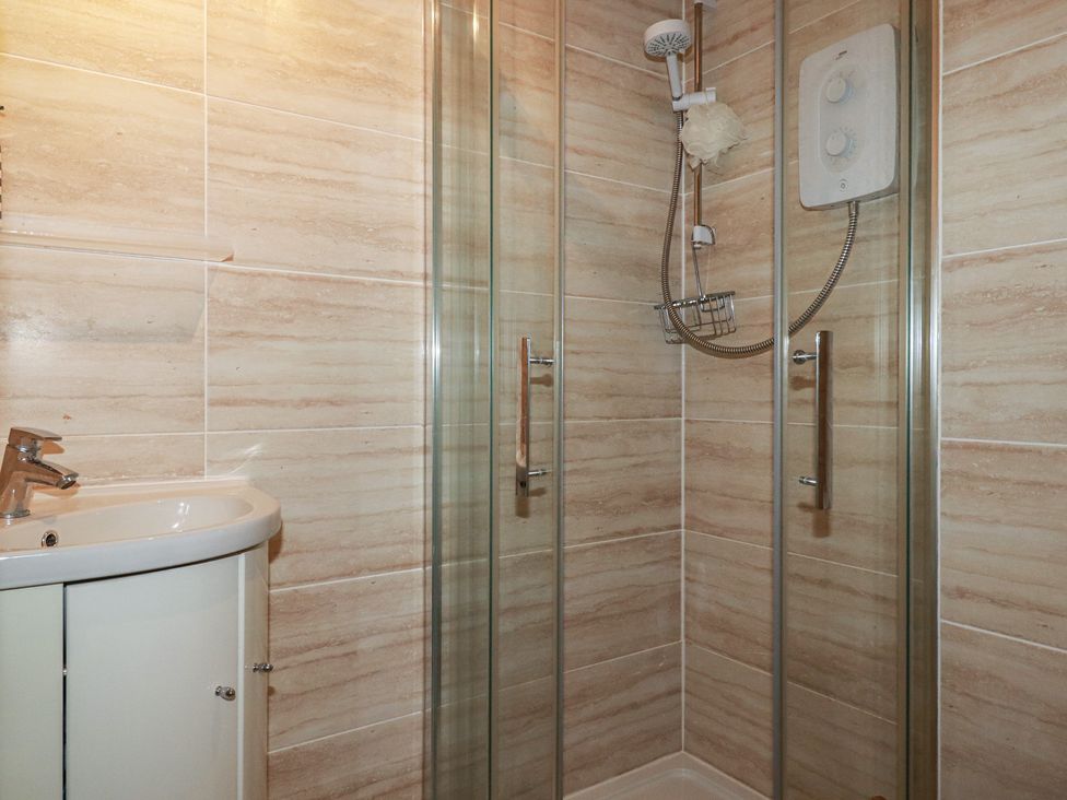A bathroom with a shower and sink at 140 Atlantic Reach in Newquay