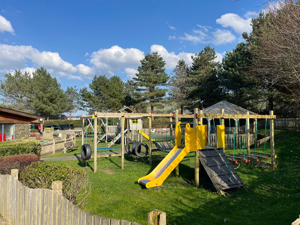 A playground with a slide and climbing frame at 26 Ocean View in Llwyngwril
