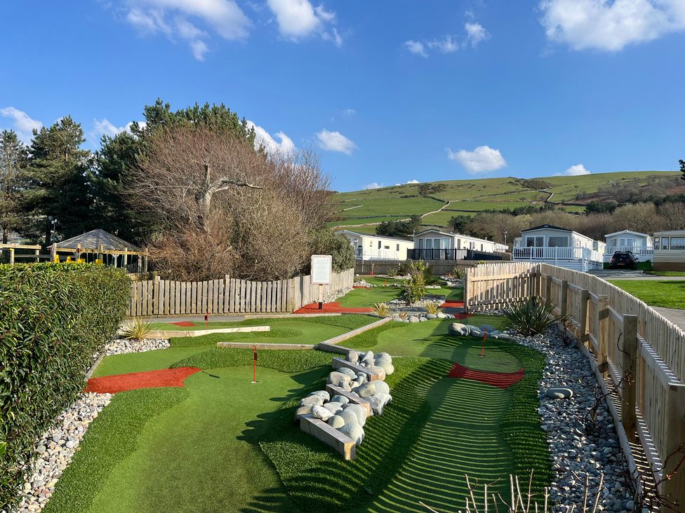 A mini golf course with artificial grass and trees at 26 Ocean View in Llwyngwril