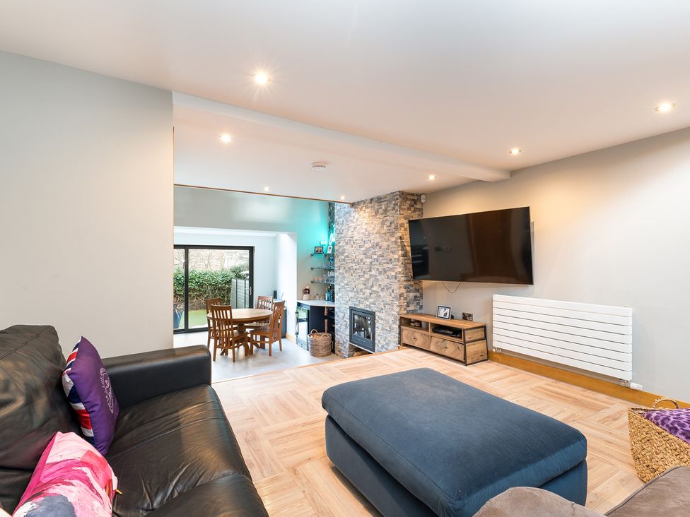 A living room with a sofa and dining table at The Grand Weave House in Shipley