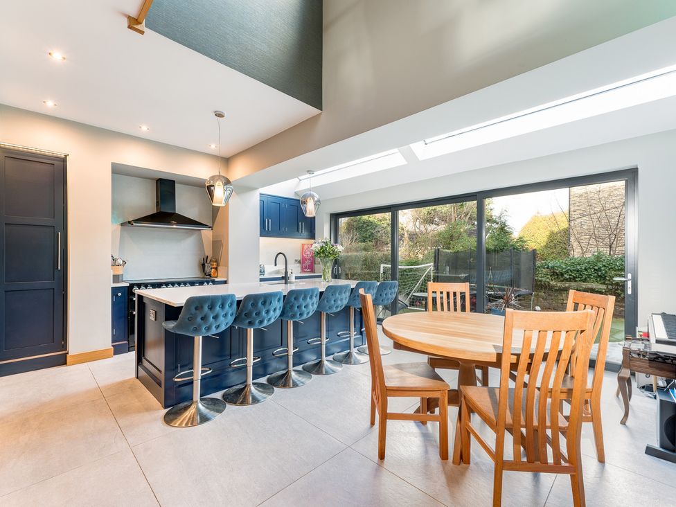 A kitchen with an island and dining area at The Grand Weave House in Shipley