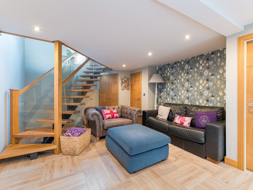 A living room with staircase and sofas at The Grand Weave House in Shipley