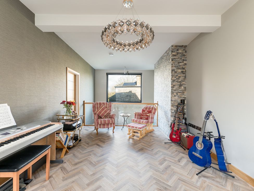 A snug with chairs and musical instruments at The Grand Weave House in Shipley