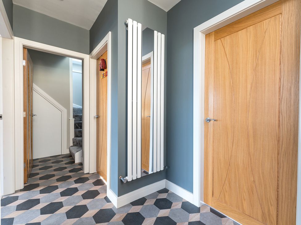 A hallway with a radiator and doors at The Grand Weave House in Shipley