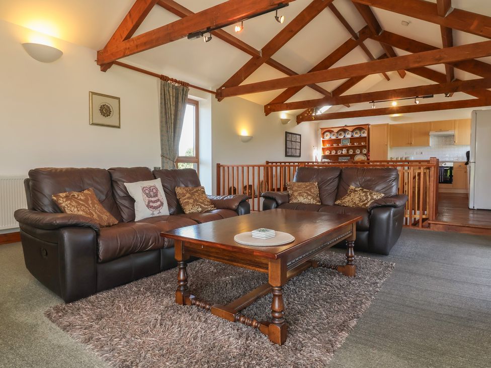 A living room with a sofa and coffee table at Little Owl Barn in Wellington