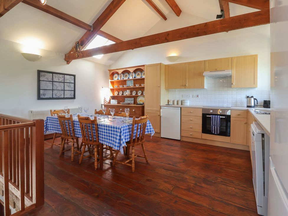 A kitchen with a dining table and chairs at Little Owl Barn Wellington