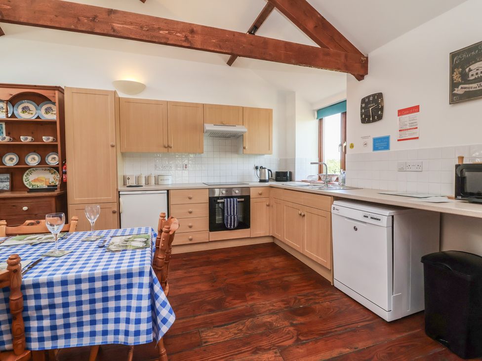A kitchen with a dining table and chairs at Little Owl Barn Wellington