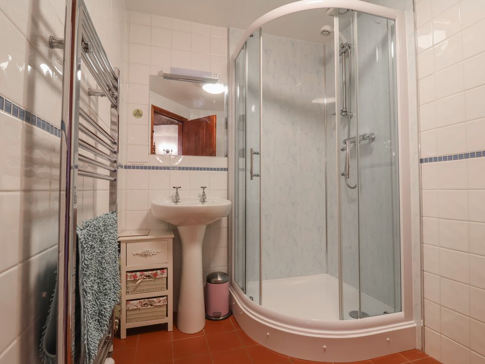 A bathroom with a shower, sink, and towel rack at Little Owl Barn in Wellington