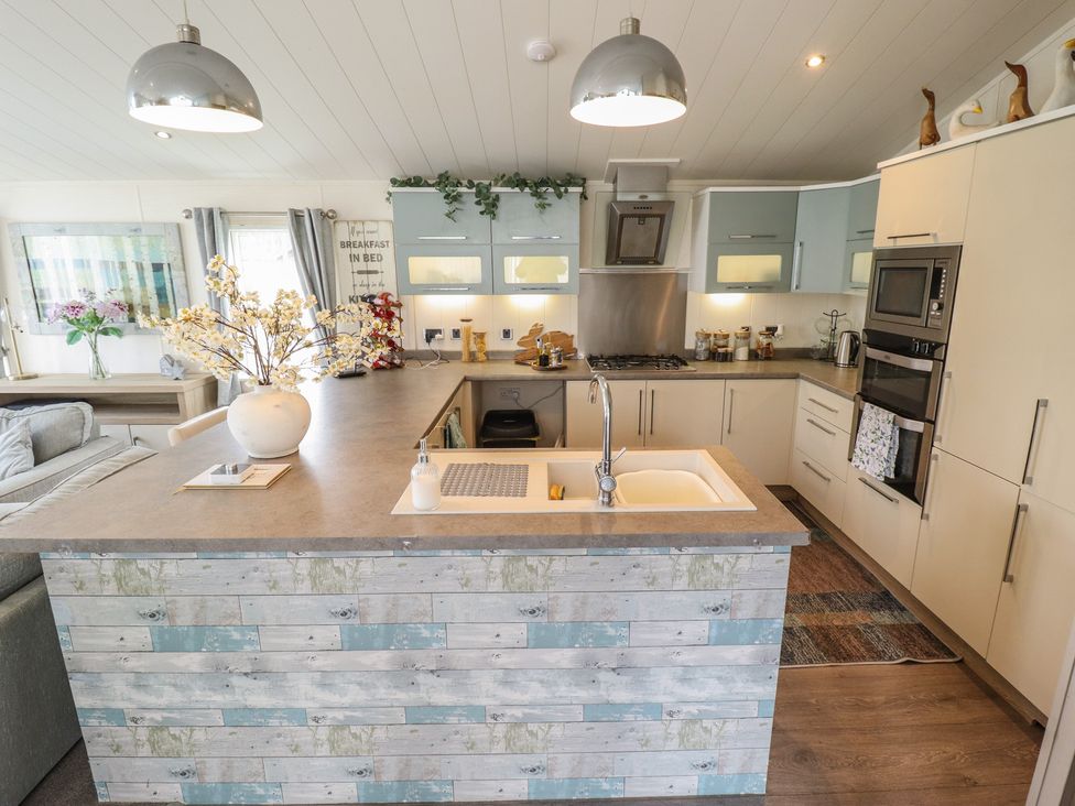 A kitchen with an island and appliances at P and M Luxury Lodge BR15 Tattershall