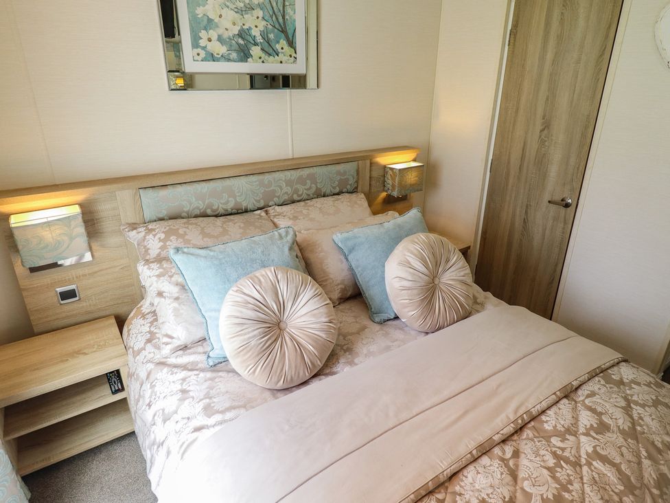 A bedroom with a bed and bedside table at P and M Luxury Lodge BR15 Tattershall