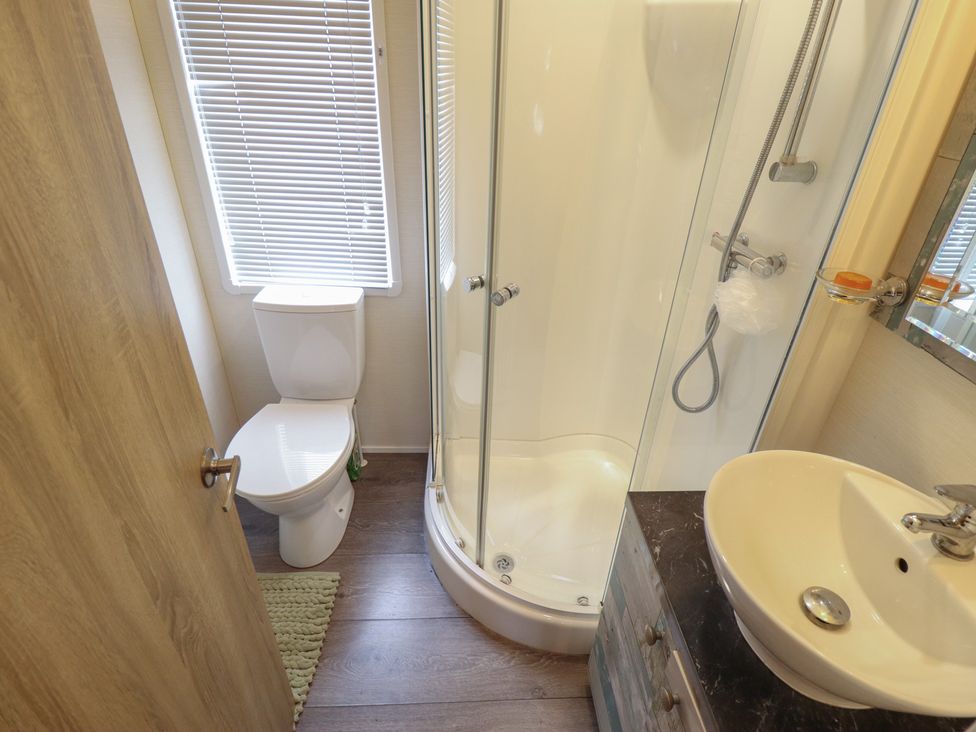 A bathroom with a shower, toilet, and sink at P and M Luxury Lodge BR15 Tattershall