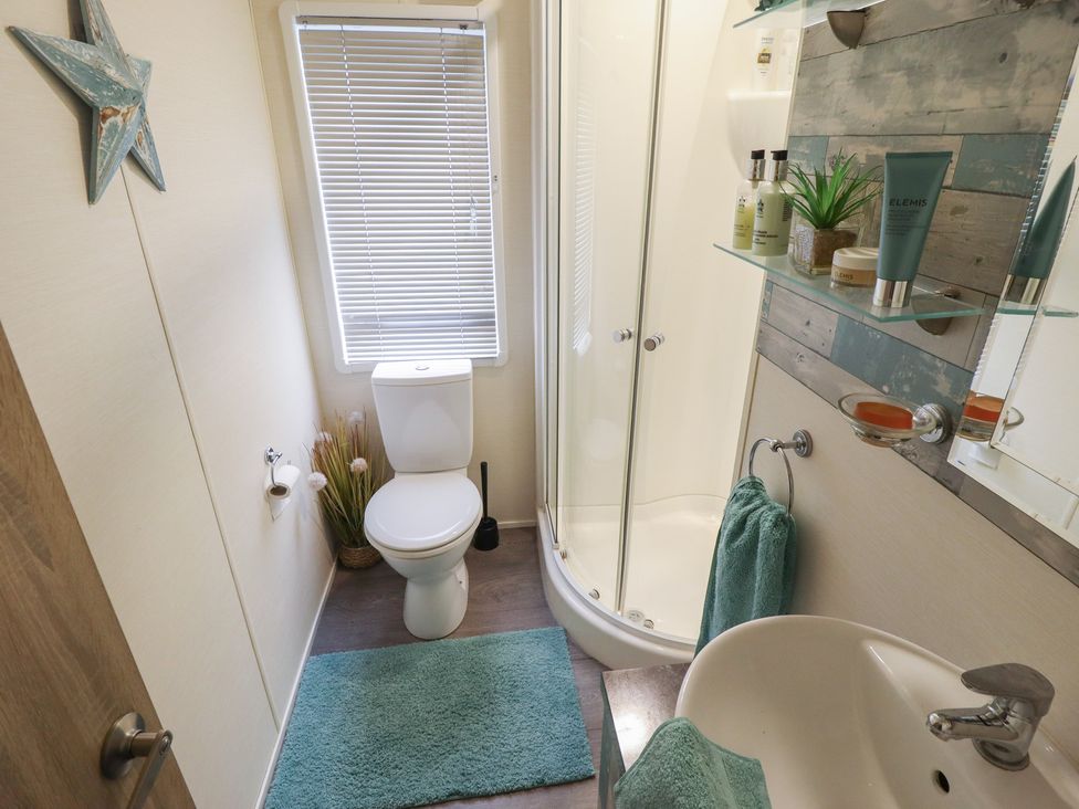 A bathroom with a toilet, shower, and sink at P and M Luxury Lodge BR15 in Tattershall