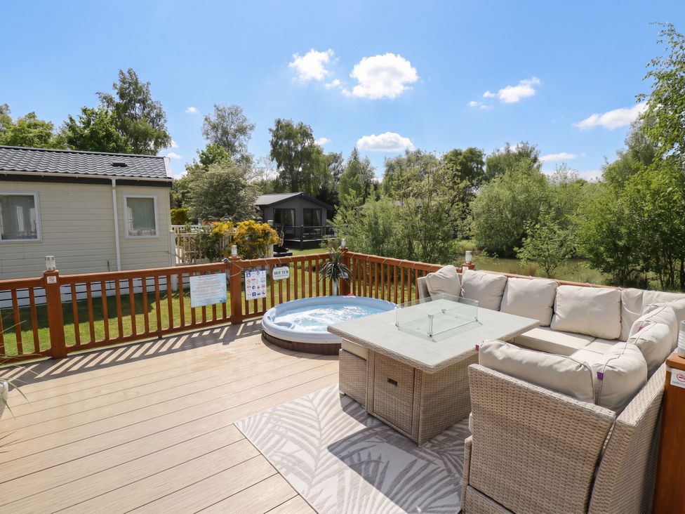 An outdoor patio with a hot tub and seating area at P and M Luxury Lodge BR15 in Tattershall