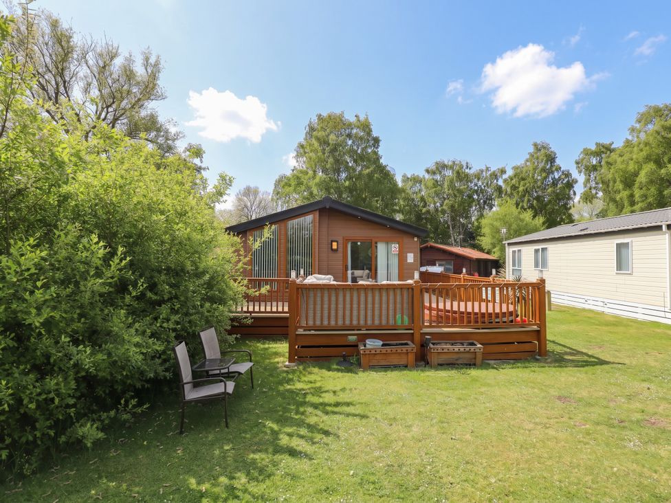 A house with decking and seating area at P and M Luxury Lodge BR15 Tattershall