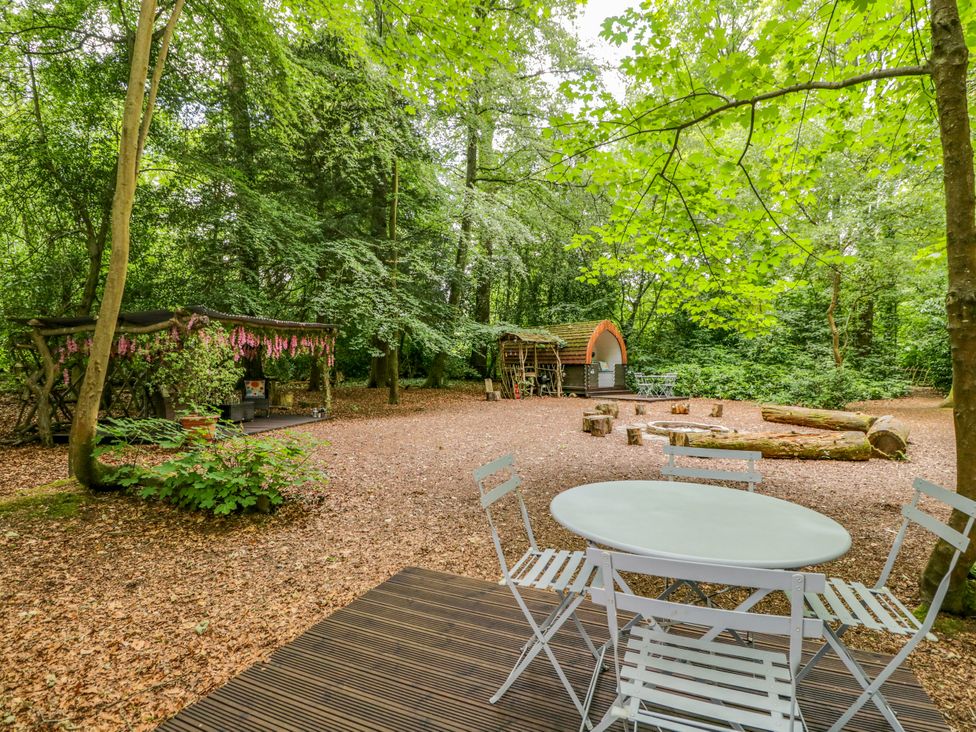 An outdoor area with a table and chairs at Bluebell Glamping Pod in Woolton Hill