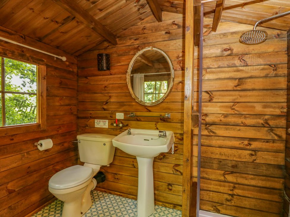 A bathroom with a toilet, sink, and shower at Bluebell Glamping Pod in Woolton Hill