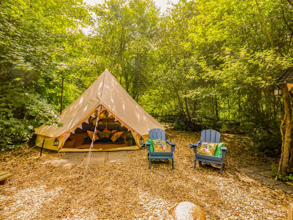 A bell tent with two blue chairs outside at Jungle Bell Tent in Woolton Hill