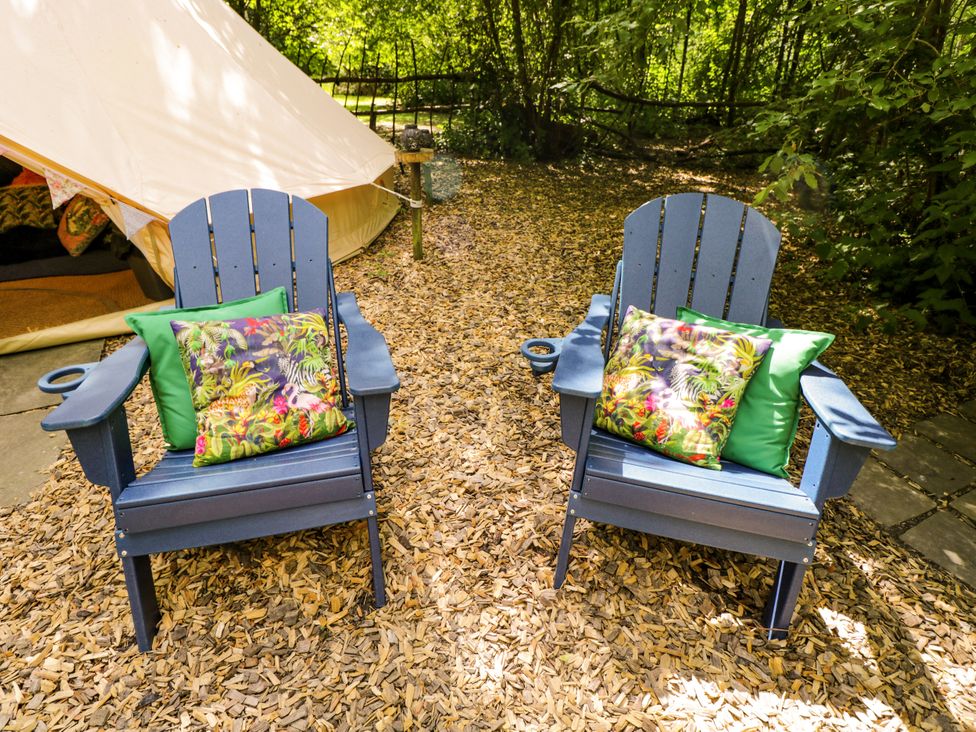 Two adirondack chairs with cushions at Jungle Bell Tent Woolton Hill