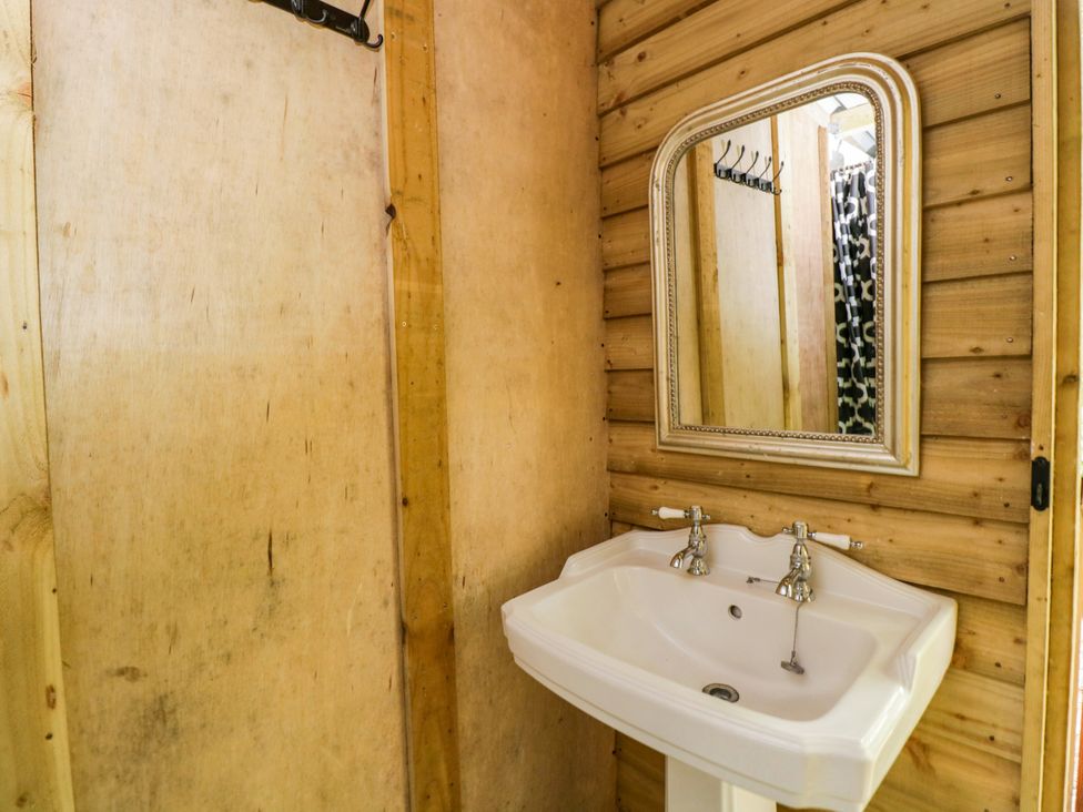 A bathroom with a sink and mirror at The Moroccan Bell Tent in Woolton Hill