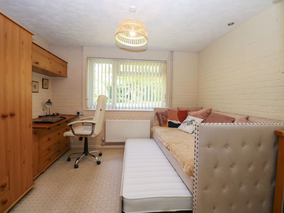 A bedroom with a desk, chair, and sofa at 51 Colin McLean Road in Dereham
