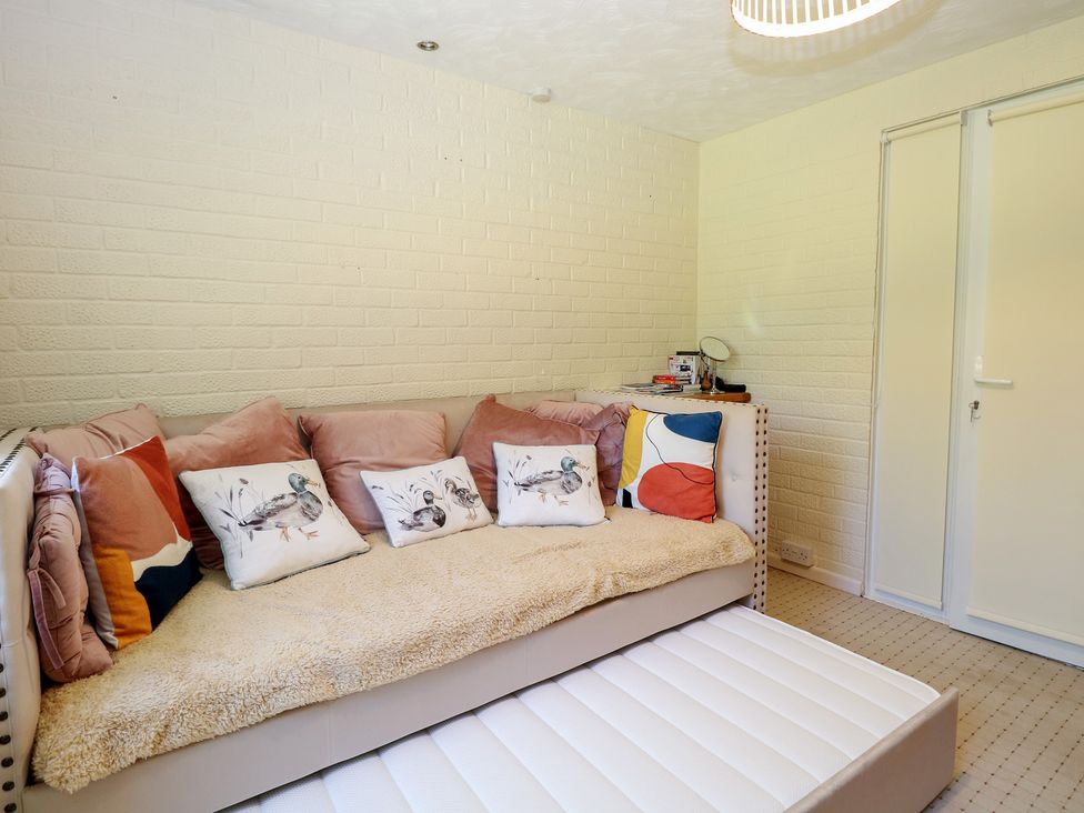 A snug with a sofa and cushions at 51 Colin McLean Road Dereham