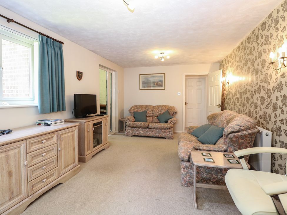 A living room with sofas and television at 51 Colin McLean Road Dereham
