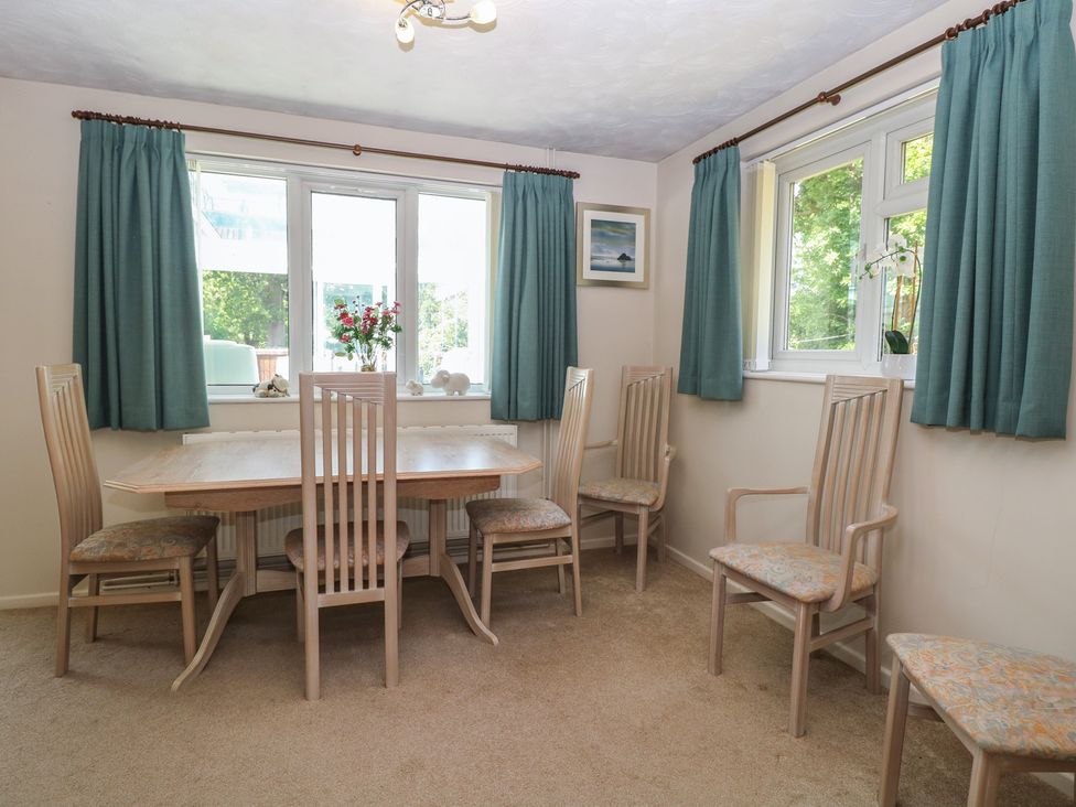 A dining room with a table and chairs at 51 Colin McLean Road in Dereham