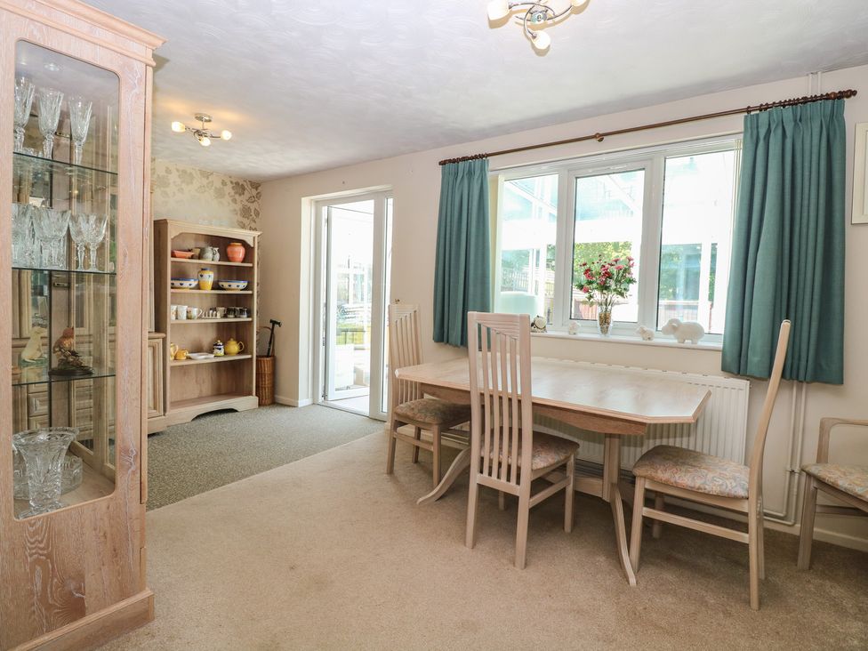 A dining room with a table and chairs at 51 Colin McLean Road Dereham