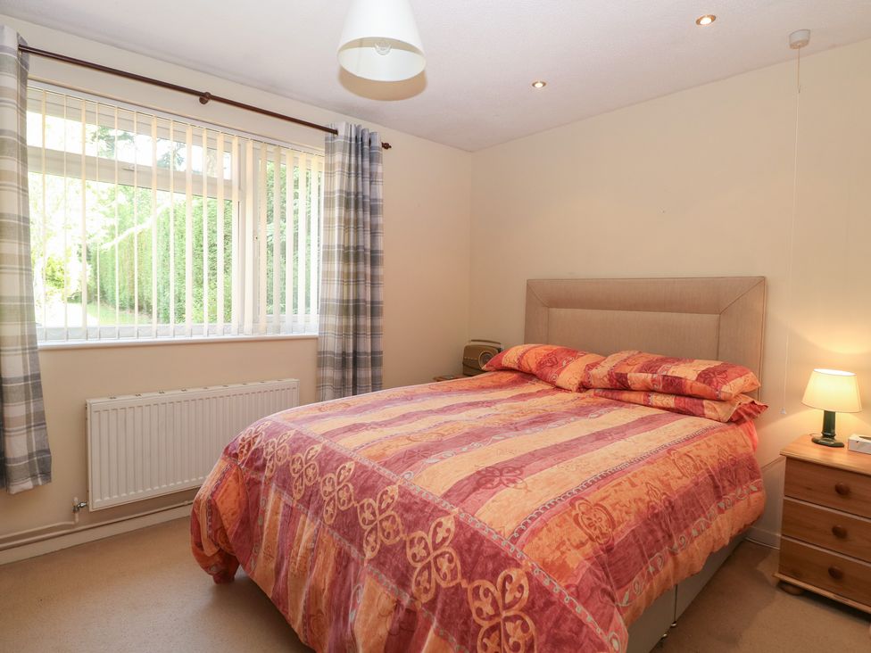 A bedroom with a bed and bedside table at 51 Colin McLean Road Dereham