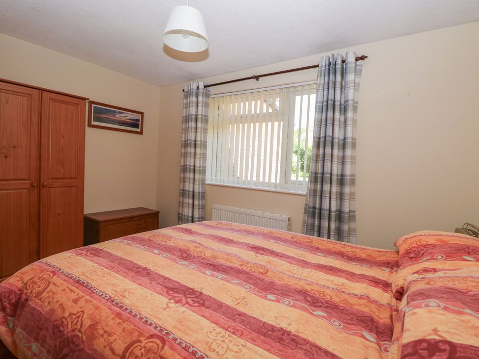 A bedroom with a bed and wardrobe at 51 Colin McLean Road in Dereham