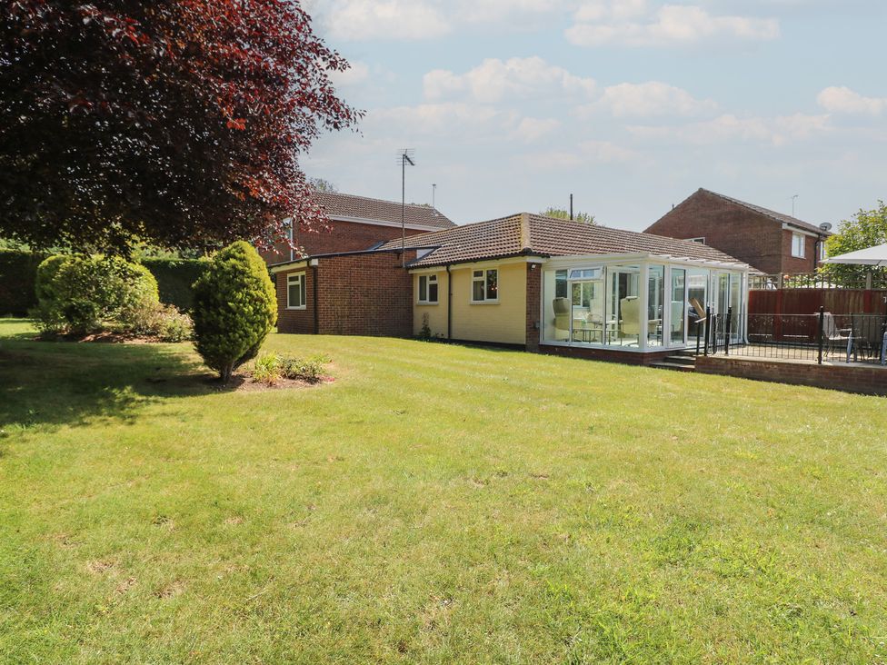 A house with a conservatory and garden at 51 Colin McLean Road in Dereham