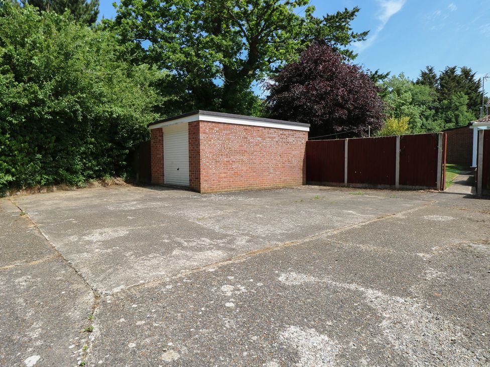 An outdoor area with a garage and concrete surface at 51 Colin McLean Road Dereham