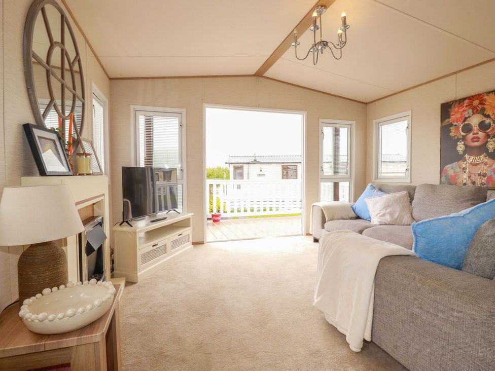 A living room with a sofa and television at CC2