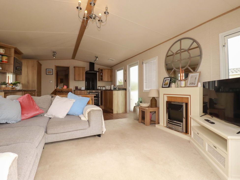 A living room with a sofa and television at CC2