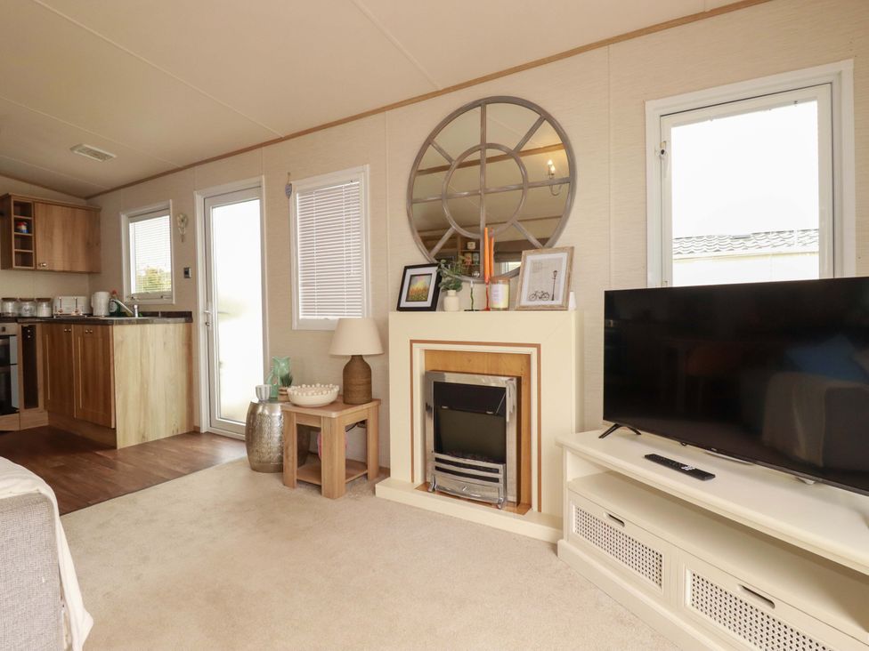 A living room with a television and fireplace at CC2