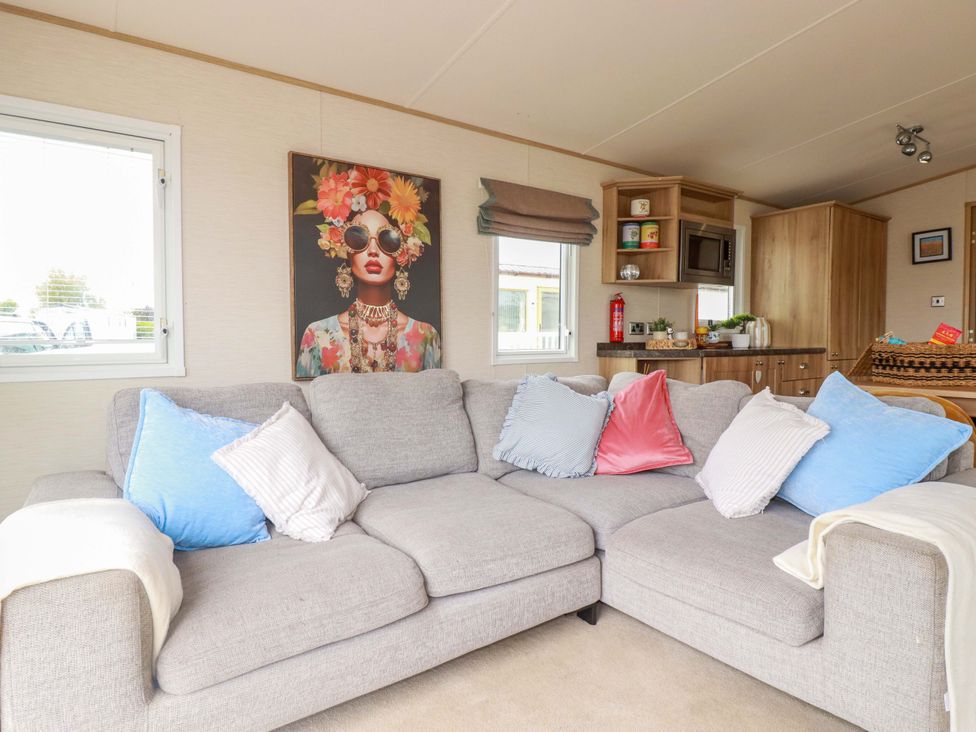 A living room with a sofa and wall art at CC2