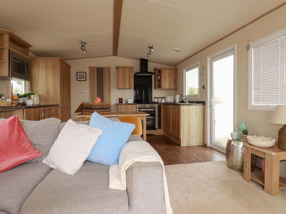 A kitchen with a dining table and sofa at CC2