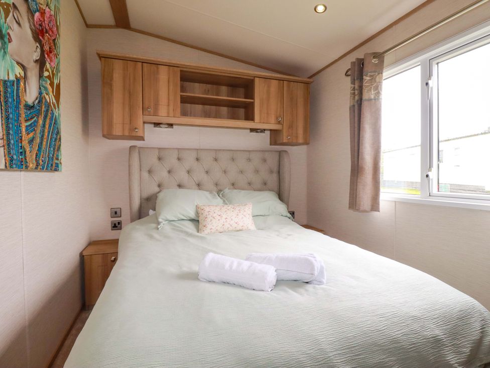 A bedroom with a bed and wall art at CC2