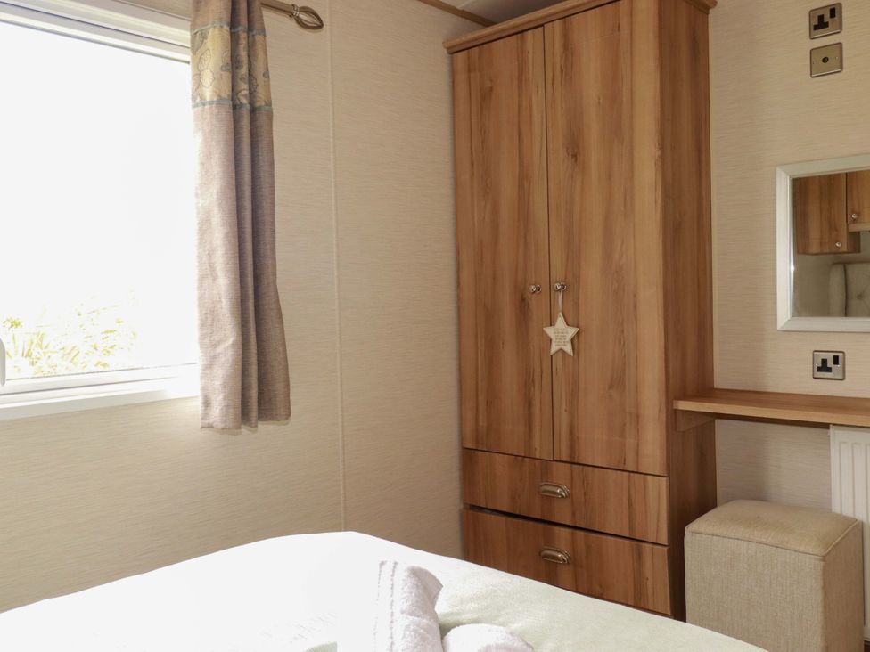 A bedroom with a wardrobe and a mirror at CC2