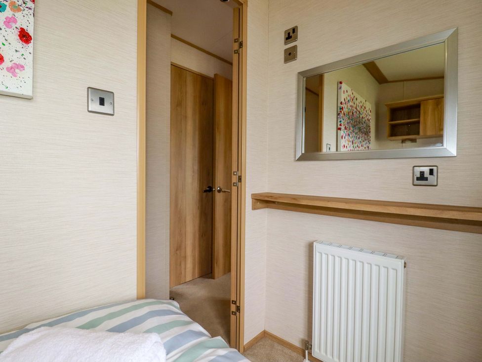 A bedroom with a mirror and a shelf at CC2
