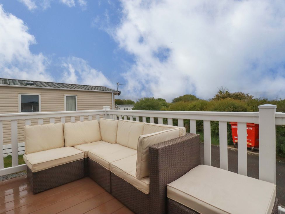 An outdoor area with a sofa and railing at CC2