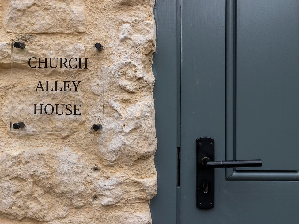 A door with a sign at Church Alley House Stow-On-The-Wold