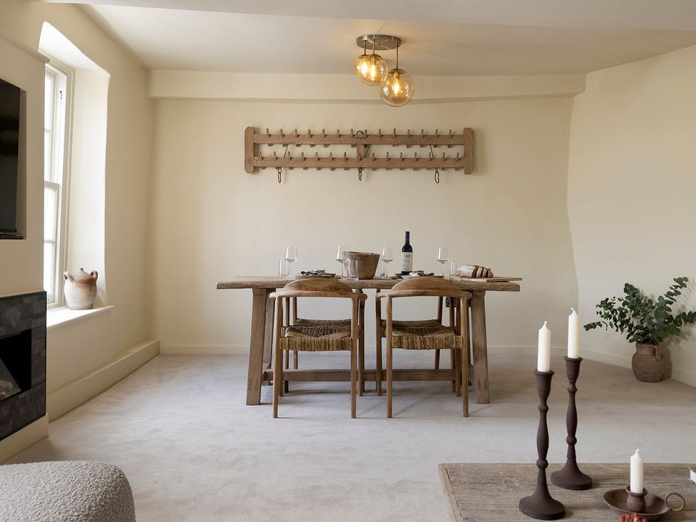 A dining room with a table and chairs at Church Alley House Stow-On-The-Wold