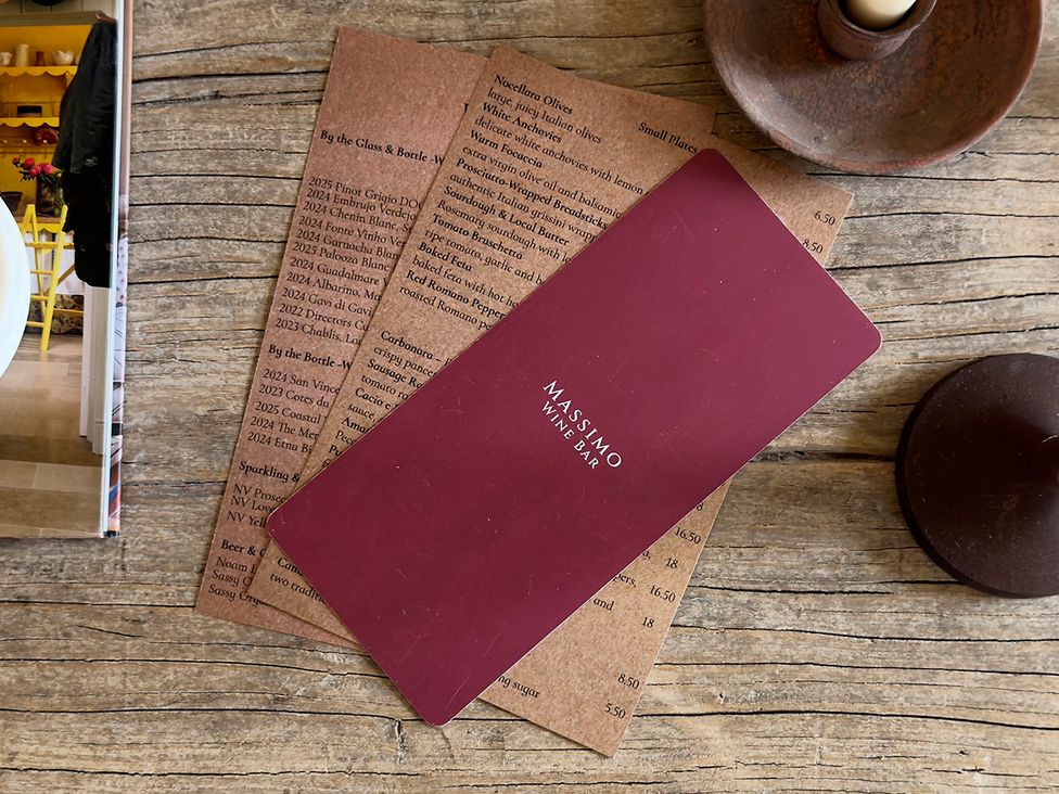 A wine and food menu on a wooden table at Church Alley House Stow-On-The-Wold